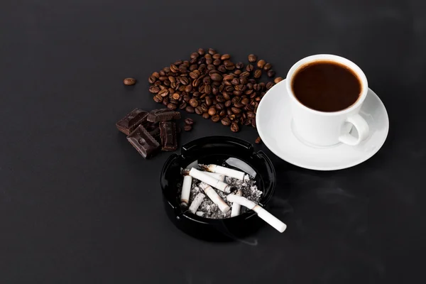 Cup of coffee and ashtray with cigarettes — Stock Photo, Image