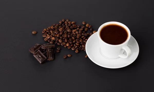 Cup of coffee with chocolate and beans — Stock Photo, Image