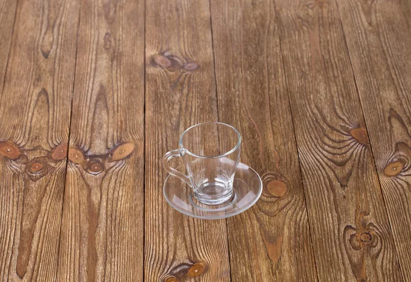 Empty cup with dish isolated on wooden texture — Stock Photo, Image