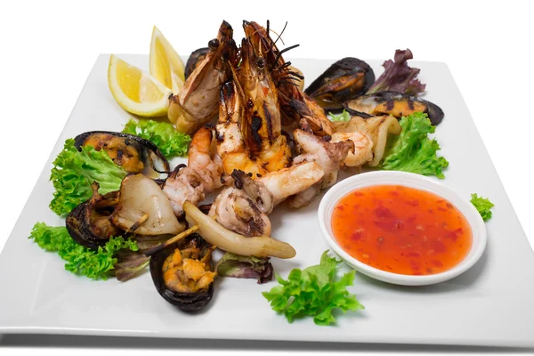 Grilled seafood platter with hot sauce. — Stock Photo, Image