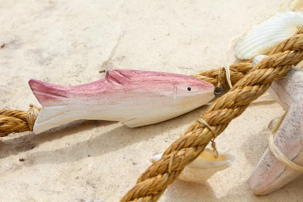 Wooden fish and rope — Stock Photo, Image