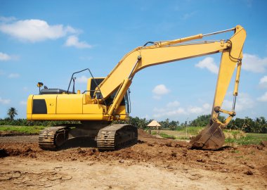 Excavator working at construction site clipart