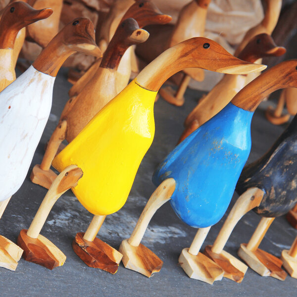 Colorful wooden figurines of ducks, selective Focus