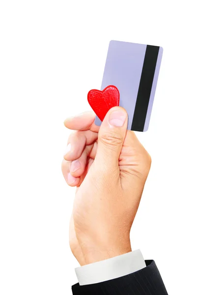 Hombre sosteniendo una tarjeta de crédito y un pequeño corazón aislado fondo blanco —  Fotos de Stock