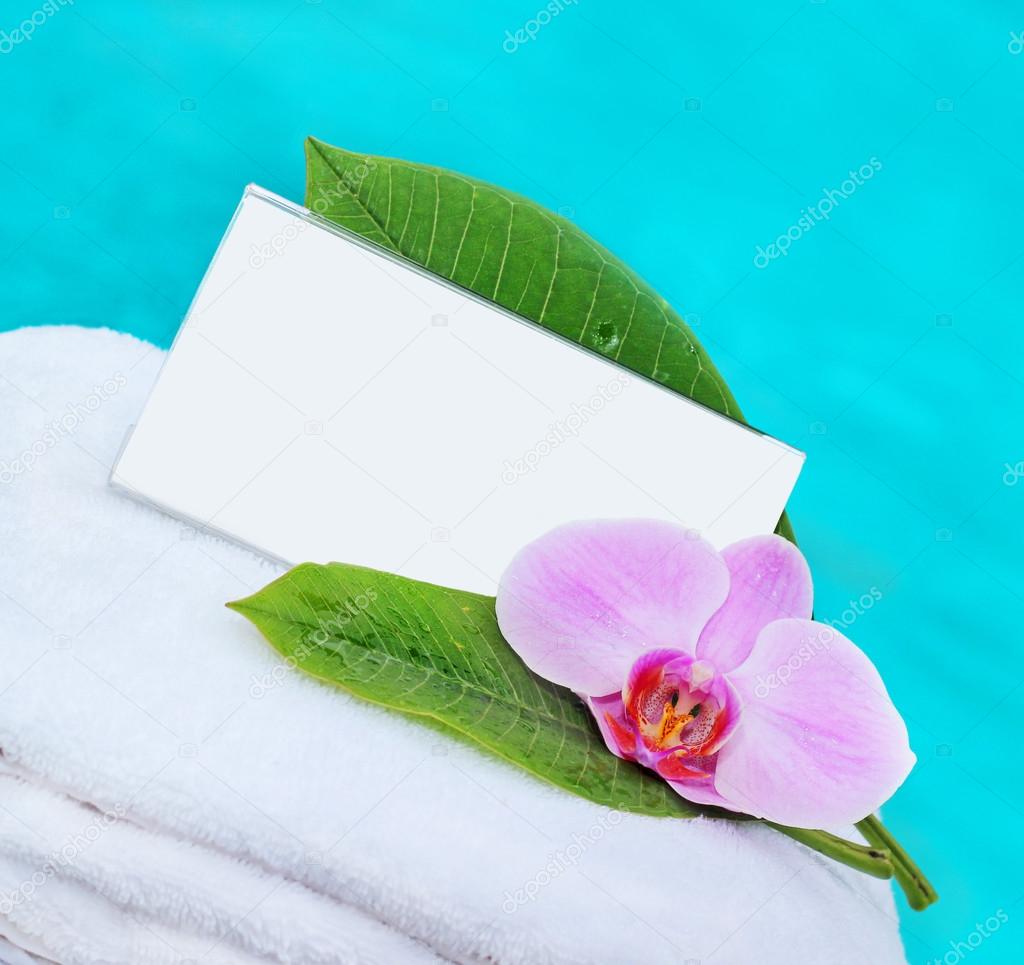 Card and flower on a white towel