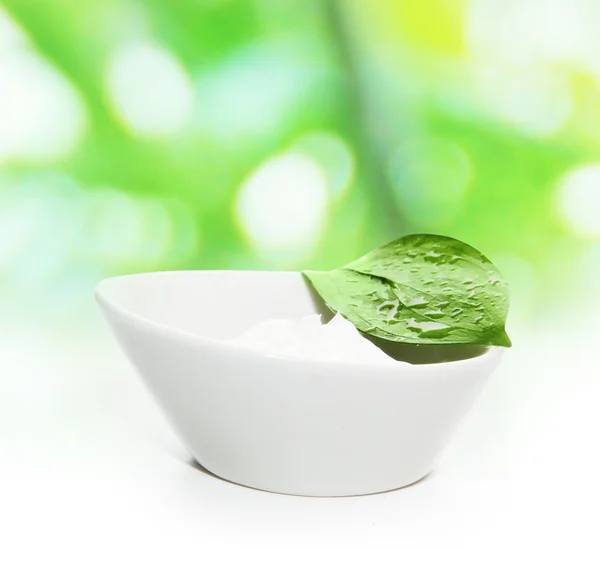 Cream with green leaf — Stock Photo, Image