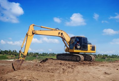 Excavator working at construction site clipart