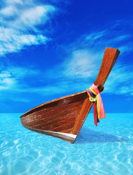 Коричневая деревянная лодка в синем море
