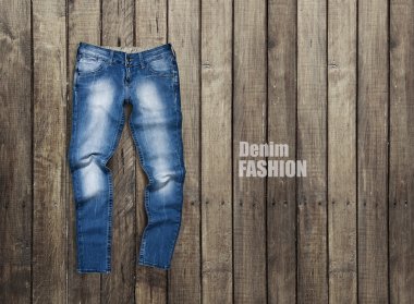 Jeans on a wooden background clipart