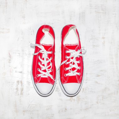Red shoes on a wooden background clipart