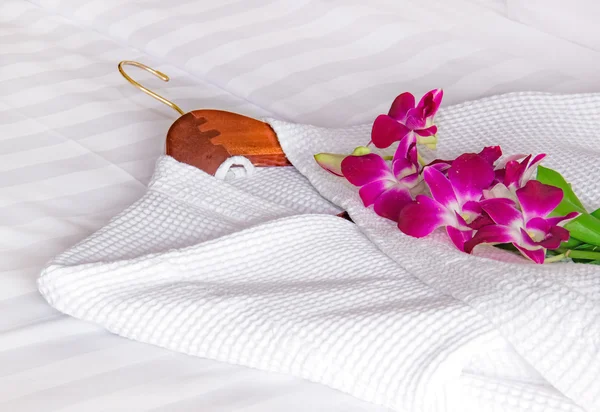 White bathrobe on the bed — Stock Photo, Image