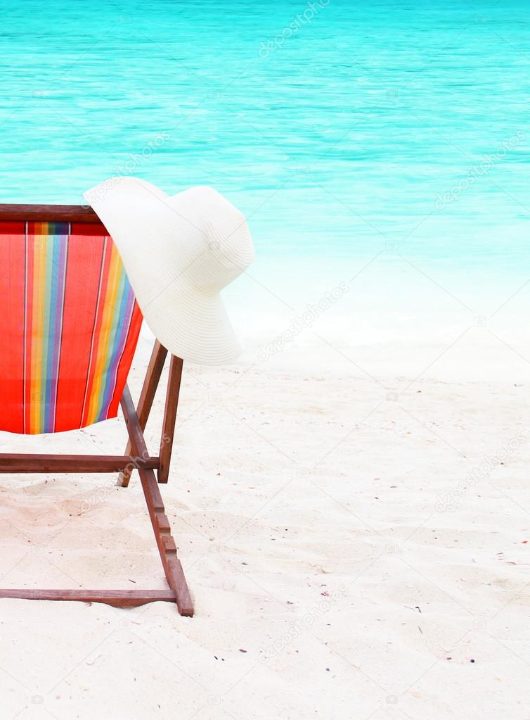 chair with a hat on the beach