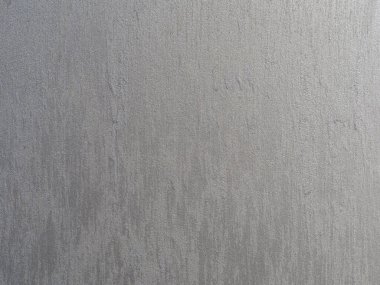 Duvarın dokusu soyut dekoratif alçıyla süslenmiş.