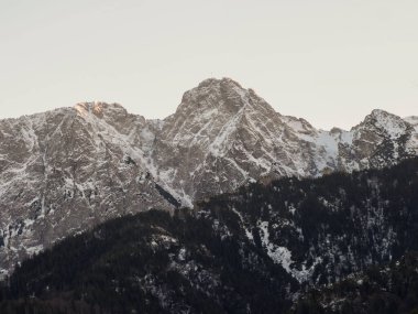 Close up view of the snow covered mountain peak during sunset in Tatra