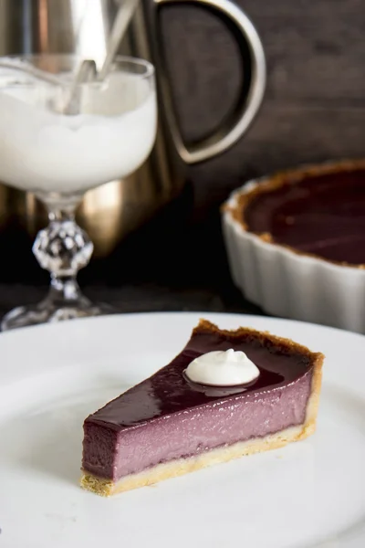 berry tart beyaz bir plaka üzerinde bir parça