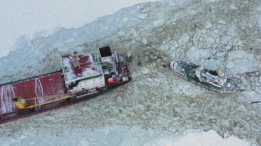 Arkhangelsk, Rusya - 14 Şubat 2021: Toplu taşıma gemisi buzun üzerinde bir deniz römorkörü tarafından çekildi.