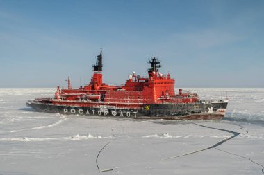 Sabetta, Tyumen region, Russia - March 22, 2021: The Ymal icebreaker moves into ices.  clipart