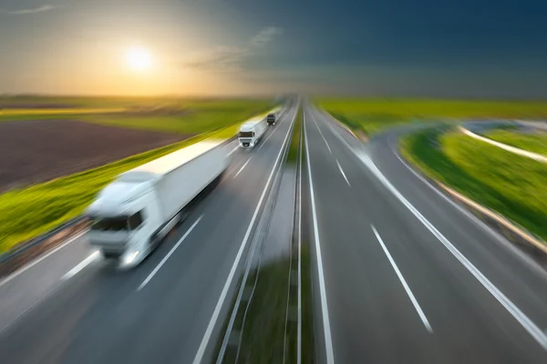 Motion image of modern delivery trucks on the highway — Stock Photo, Image