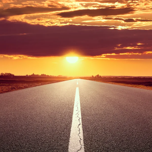 Driving on an empty road at sunset — Stock Photo, Image