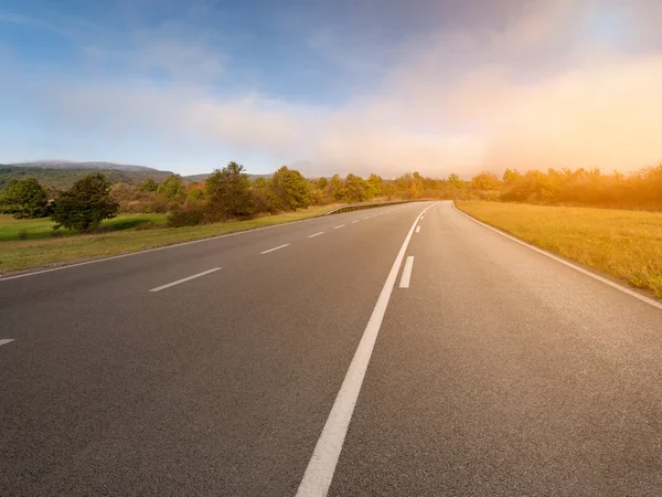 Driving on an empty asphalt road at autumn — Stock Photo, Image