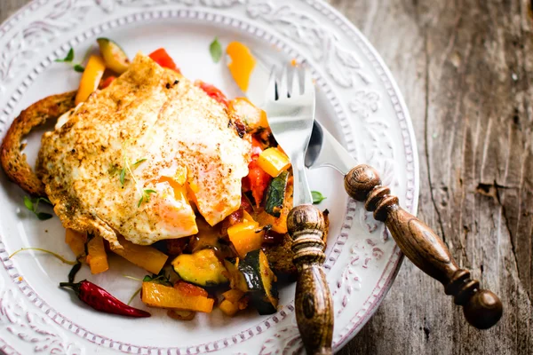 Œuf frit et légumes rôtis sur tranche de pain croustillante — Photo