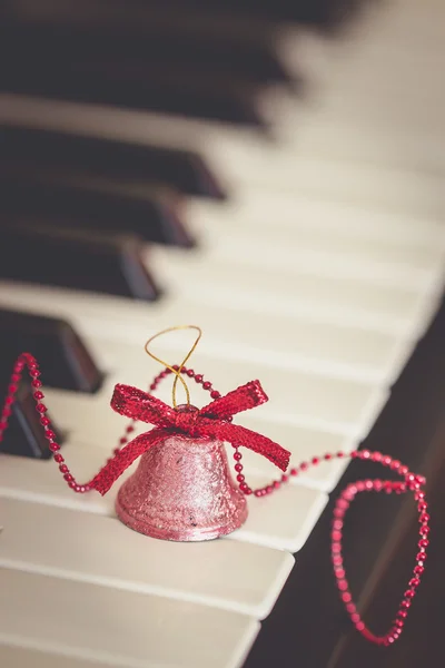 Bell on piano keys — Stock Photo, Image