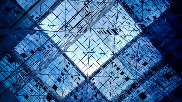 The glass dome of the office building and the mirrored facade reflecting the sky and elements of the structure of the building,View from inside the building.