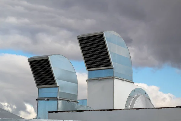 Ventilation and air conditioning system installed on the roof of an office building, galvanized elements of air ducts.