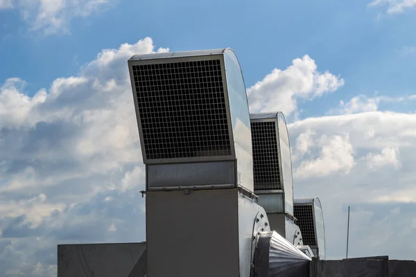 Ventilation and air conditioning system installed on the roof of an office building, galvanized elements of air ducts.