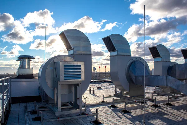 Ventilation and air conditioning system installed on the roof of an office building, galvanized elements of air ducts.