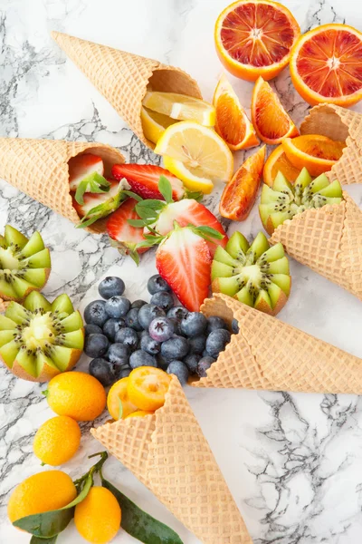 Ice cream cones with fresh fruits — Stock Photo, Image