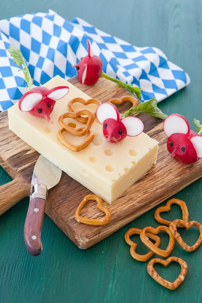 Block of hard cheese with radishes — Stock Photo, Image