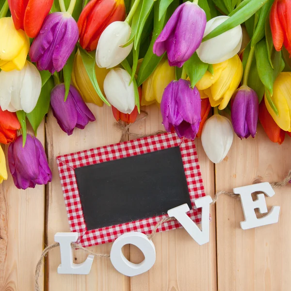 Fresh tulips on wooden background — Stock Photo, Image