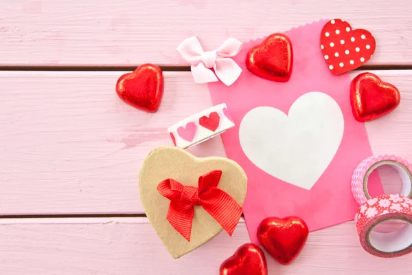 Chocolate hearts and colorful gift bag — Stock Photo, Image