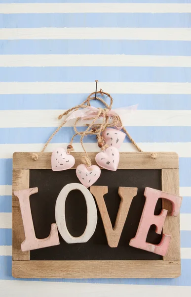 LOVE on rustic chalkboard on stripes — Stock Photo, Image