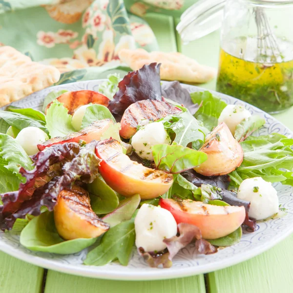 Fresh lettuce with grilled peaches