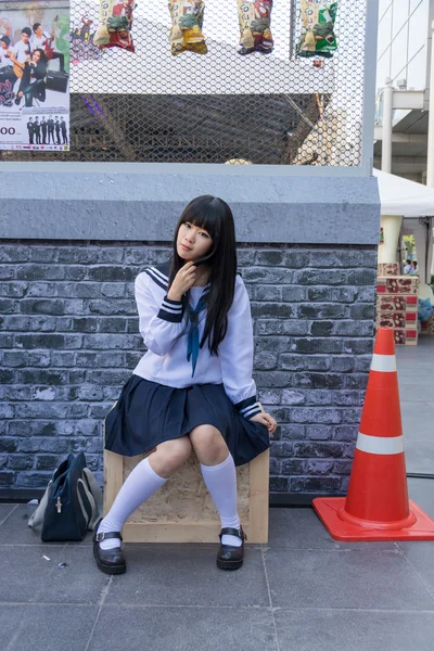 Stock Photo - BANGKOK, THAILAND - MARCH 31: Cute Thai cosplayer dresses as Japanese schoolgirl posing for photograph in 3rd Thai-Japan anime festival on March 31, 2013. — Stock Photo, Image