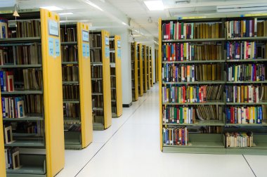 BANGKOK, THAILAND - 10 SEPTEMBER : Row of bookshelves in a public library of Thammasat University on September 10, 2014.