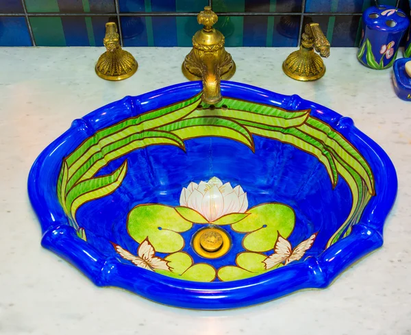 Luxury toilet sink basin with water golden water tap, decorate in marine style interior