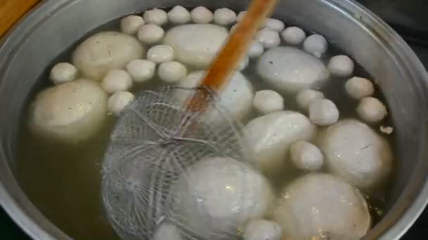 Giant meatball soup with metal ladle sieve picking ready to serve in Thailand outdoor restaurant in 1928x1080 HD. It's a traditional rare Thai cuisine food gourmet. — Stock Video