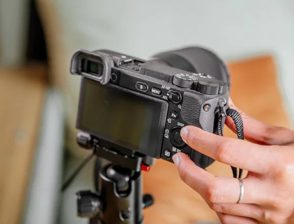 Asian female blogger setting up her digital camera before making a new video for vlog