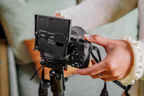 Asian female blogger setting up her digital camera before making a new video for vlog