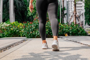 Asyalı sporcu kız dışarıda esneme, yoga ve kalas egzersizi yapıyor. Formda genç Taylandlı kadın sabah antrenman yapıyor..