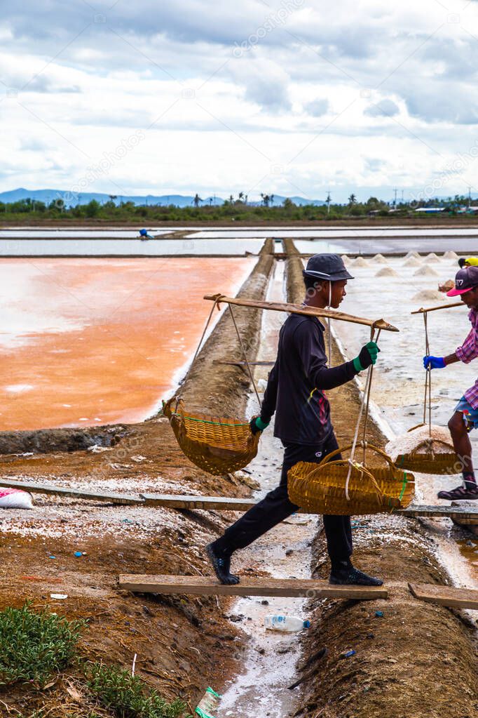 Phetchaburi Salt flats Naklua, farms and farmers collecting salt in Phetchaburi, Thailand