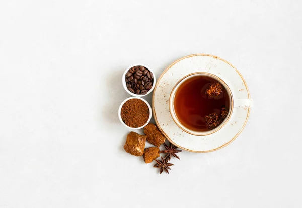 Cup with mushroom chaga drink and coffee on a white background. Trendy superfood. View from above. Copy space.