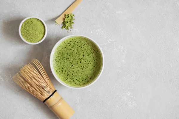 Matcha green tea set on a gray concrete background. Japanese traditional drink. View from above. Copy space.
