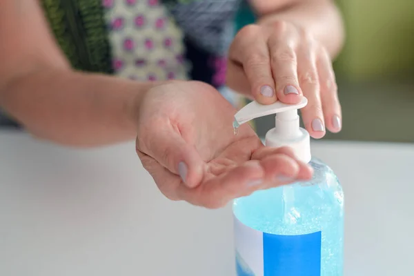 woman disinfects hands close-up, hygiene concept, pandemic