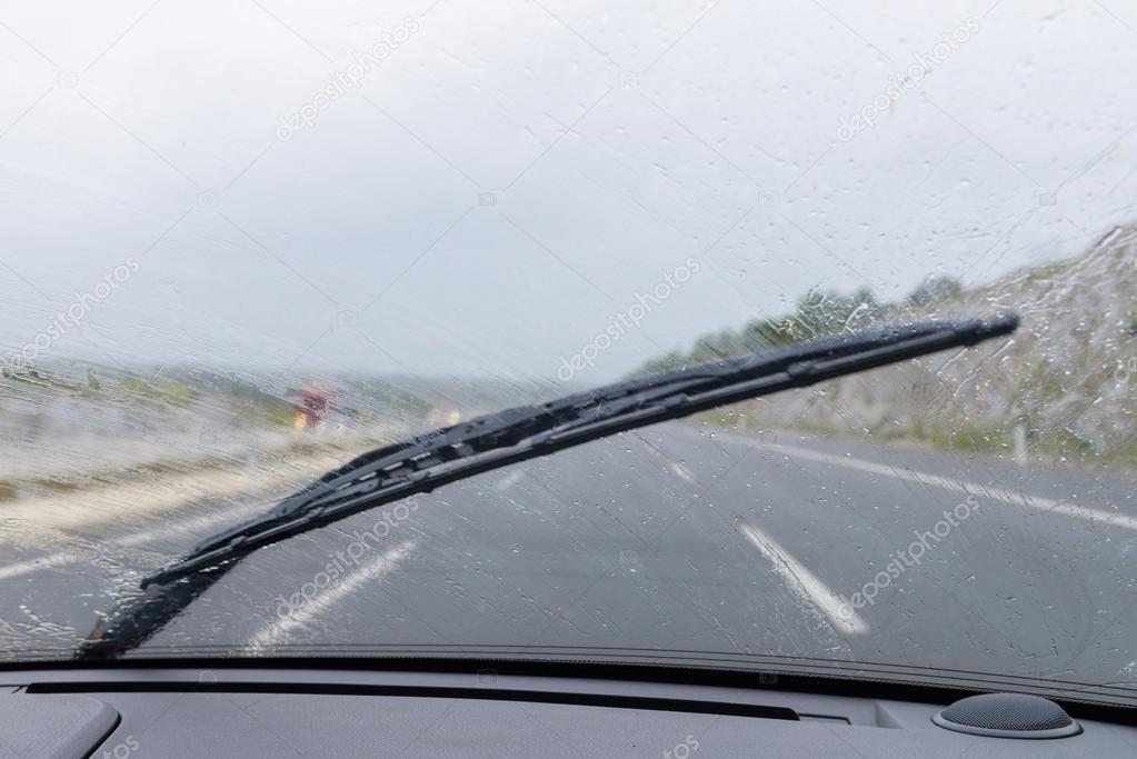wipers on the windshield of the car in the rain