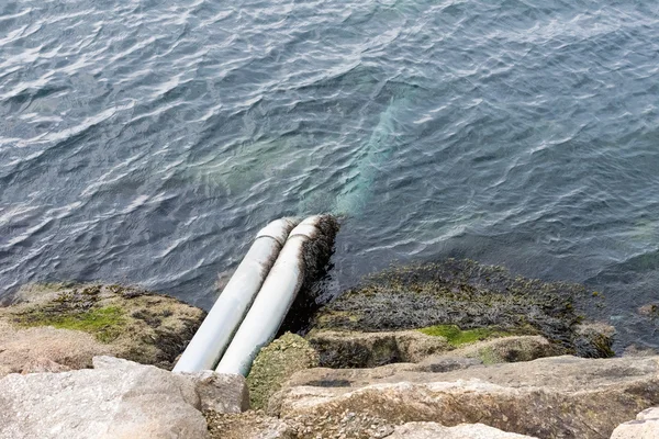 Pipe for draining sewage into the ocean — Stock Photo, Image