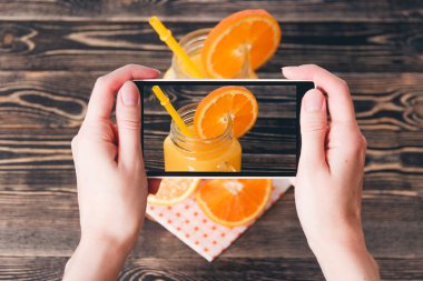 Portakal fotoğrafta eller. Teknoloji kavramı